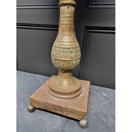 1174 - A Dutch embossed brass pedestal jardiniere, 81cm high.