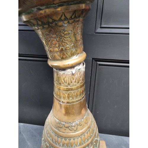 1174 - A Dutch embossed brass pedestal jardiniere, 81cm high.