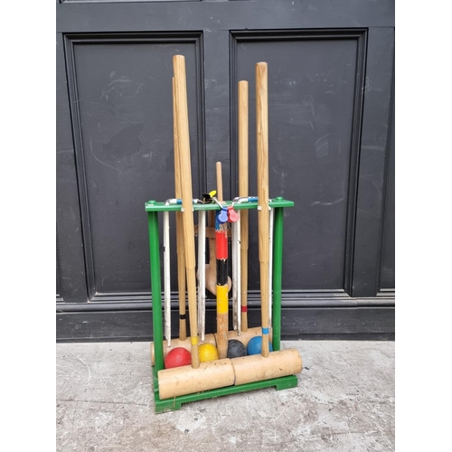 1175 - An old croquet set and stand.