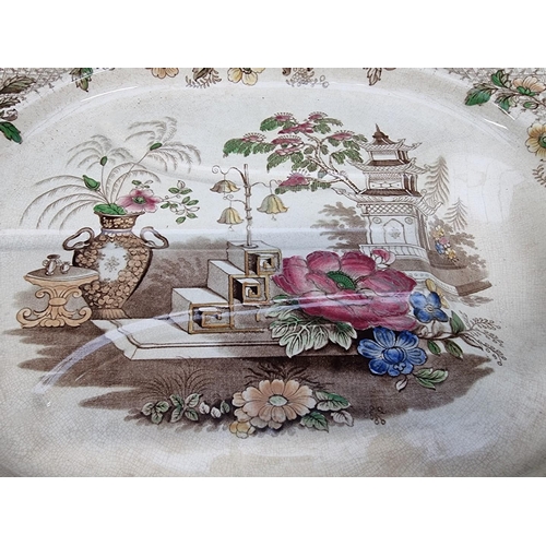 1187 - A Victorian pottery 'Tree and Well' meat plate, 49cm wide.