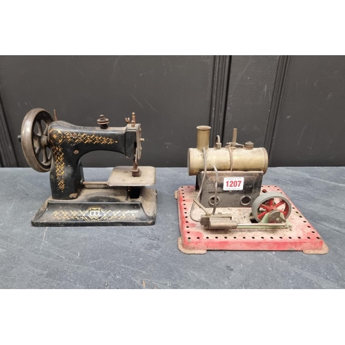 1207 - A stationary steam engine, 21cm wide; together with an antique American child's sewing machine.... 