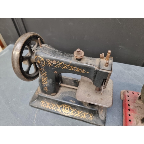 1207 - A stationary steam engine, 21cm wide; together with an antique American child's sewing machine.... 