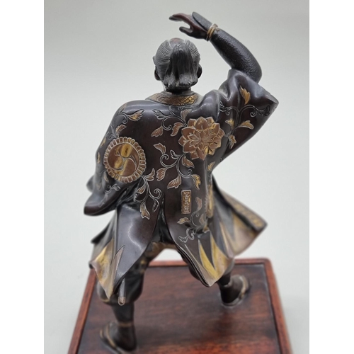 1228 - A Japanese bronze and parcel gilt figure of a Samurai, Meiji, signed Miyao, on hardwood stand, 23cm ... 