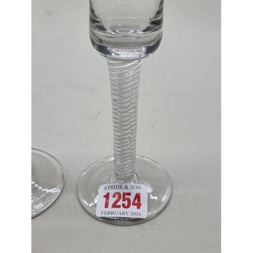 1254 - An antique double series opaque and airtwist wine glass, 17cm high; together with another opaque twi... 