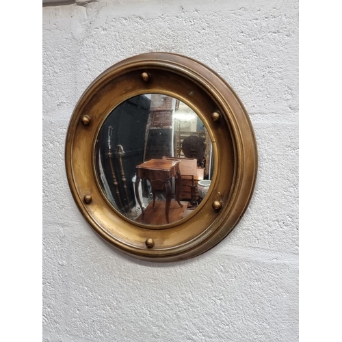 1275 - A brass framed circular wall mirror, 38cm diameter.