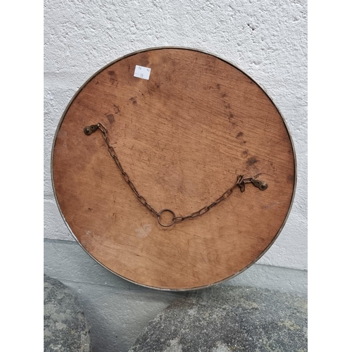 1275 - A brass framed circular wall mirror, 38cm diameter.