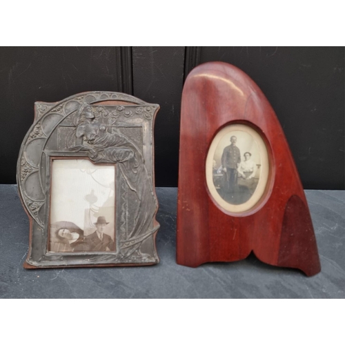 1294 - An Art Nouveau pewter photograph frame, 26.5 x 21cm; together with a novelty easel back propeller fr... 