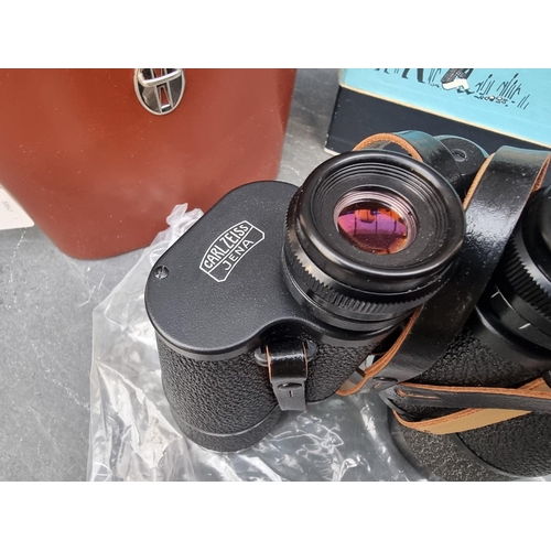 1302 - A cased pair of 'Carl Zeiss 'Jenoptem' 10x50W binoculars, in original card box, with instruction man... 