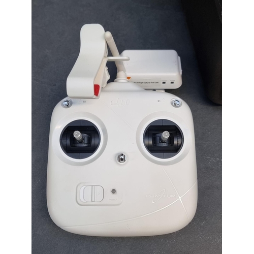 1328 - A DJI 'Phantom 2 Vision+' drone, with two batteries, charger, and controller, in fitted travel case,... 