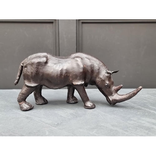 1331 - A small vintage leather Rhinoceros, in the manner of Liberty, with glass inset eyes, 52cm long.... 