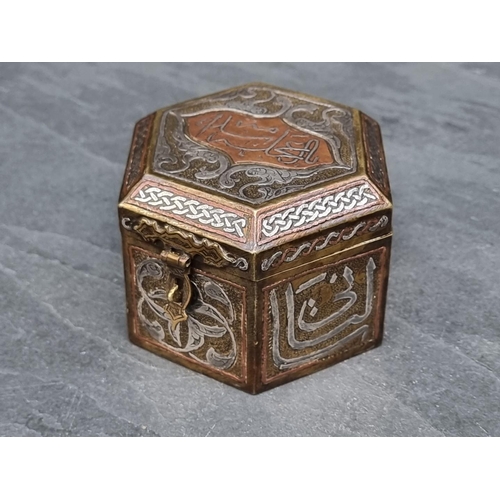 1351 - An Islamic Cairoware hexagonal casket, with script to hinged top, 10cm wide.