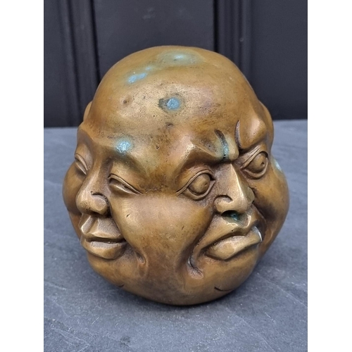 1354 - A Japanese bronze or brass 'Four Faces of Buddha' paperweight, 12.5cm high.