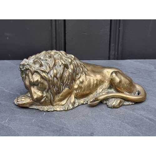 1359 - A brass recumbent lion, 21cm long.