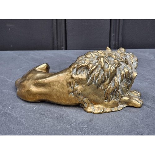 1359 - A brass recumbent lion, 21cm long.