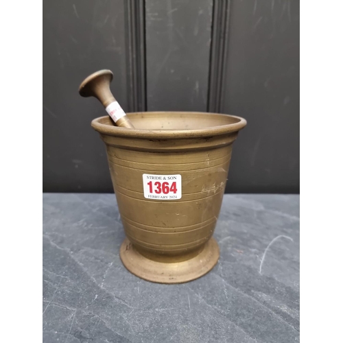 1364 - A large brass mortar, probably 18th century, with ring turned decoration, 14.5cm high x 14.3cm diame... 