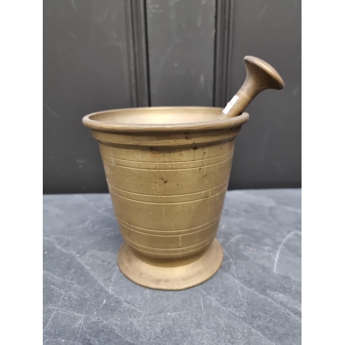 1364 - A large brass mortar, probably 18th century, with ring turned decoration, 14.5cm high x 14.3cm diame... 