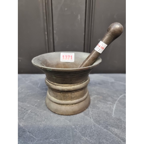 1371 - A 17th century bronze mortar, inscribed 'RO 98', 9.3cm high x 12.3cm; with 17.2cm bronze pestle. (2)... 