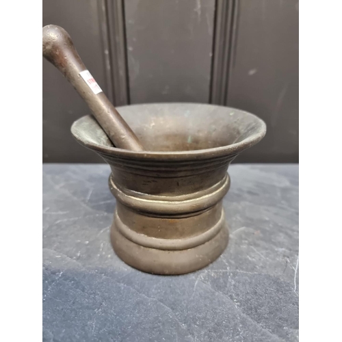 1371 - A 17th century bronze mortar, inscribed 'RO 98', 9.3cm high x 12.3cm; with 17.2cm bronze pestle. (2)... 