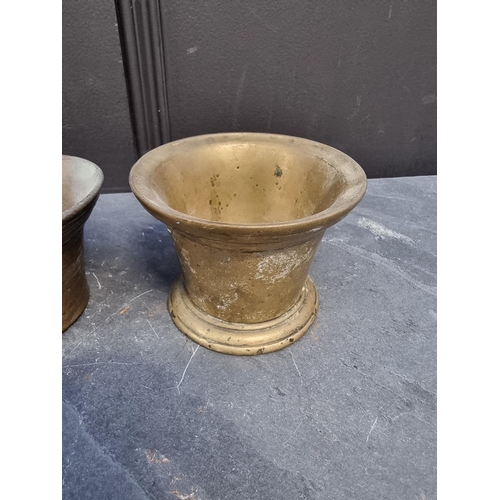 1386 - Three 17th/18th century brass or copper alloy mortars, largest 7.8cm high. (3)