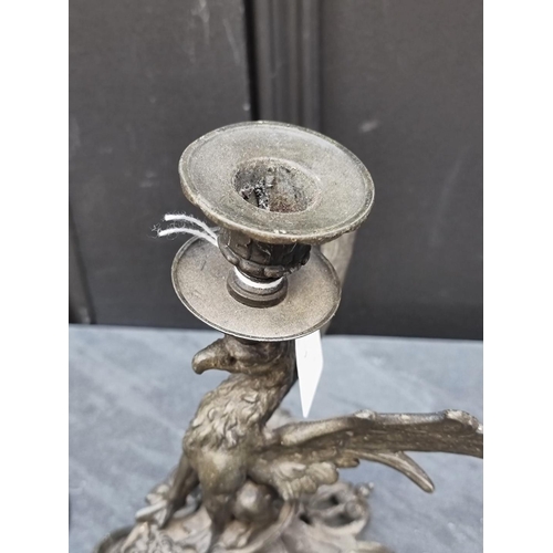 1409 - A bronze figural candlestick, 32cm high, together with another metal griffin candlestick, 19cm high.... 