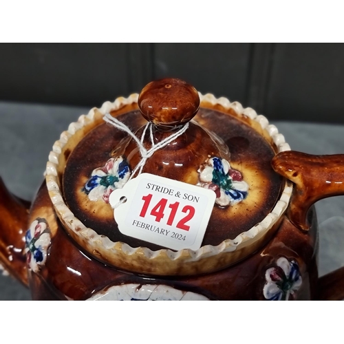 1412 - A Victorian Bargeware teapot and cover, 20cm high.