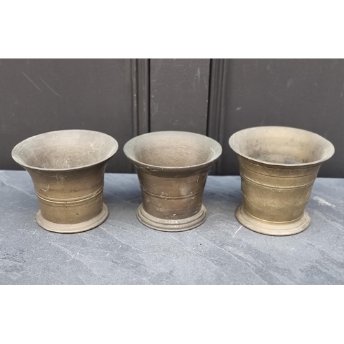 1415 - Three 18th/19th century brass mortars, largest 11.6cm high. (3)