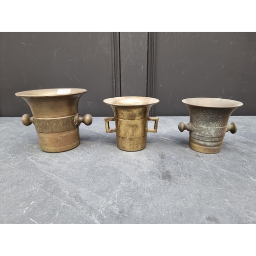 1427 - Three antique brass twin handled mortars, largest 12.6cm high x 14.2cm diameter. (3)... 