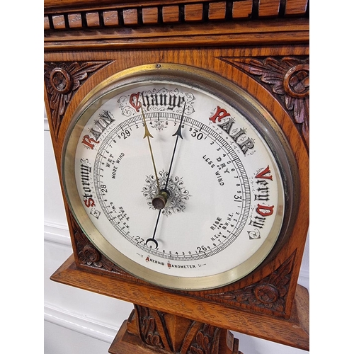 1521 - A late Victorian carved oak aneroid barometer, 92cm high.