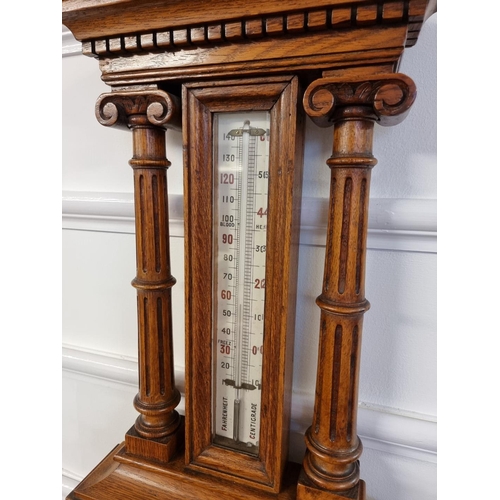 1521 - A late Victorian carved oak aneroid barometer, 92cm high.