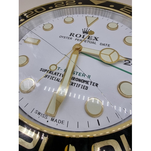 1522 - A Rolex style wall clock, with battery movement, 34cm diameter, (crack to glass).