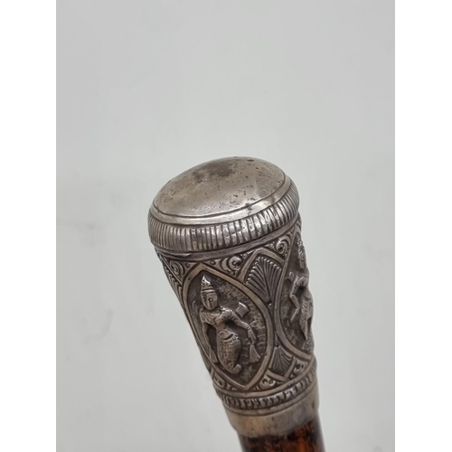 1527 - A Thai or Eastern ebonized and silver mounted cane. 