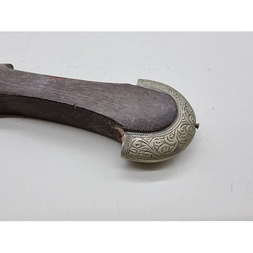 1552 - An Arab white metal mounted Jambiya and sheath, with 17.5cm decorated blade.