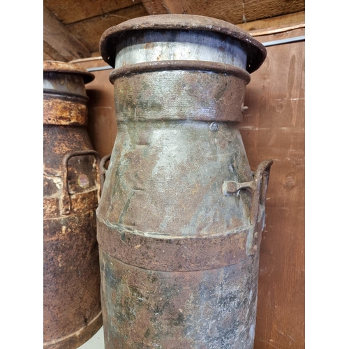 1559 - Two large old metal milk churns, inscribed 'Cadbury Bros Ltd', 75cm high.