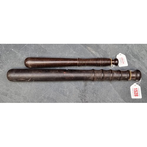 1528 - A vintage hardwood truncheon, 38cm; together with another similar example, 27.5cm. (2)... 