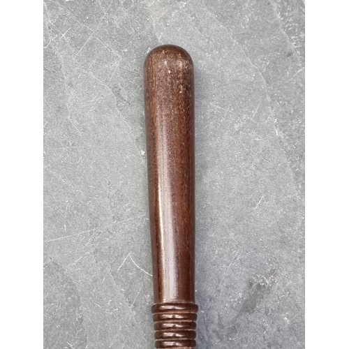 1528 - A vintage hardwood truncheon, 38cm; together with another similar example, 27.5cm. (2)... 