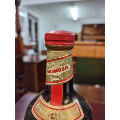 27 - Two bottles of Drambuie, comprising: a 23 3/4 fl.oz. example; and a 70cl example. (2)... 