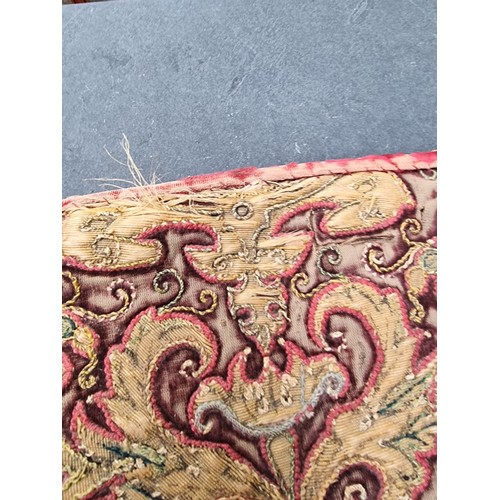 1291 - An interesting late 17th century Spanish embroidered red velvet orphrey, 101 x 22cm.... 