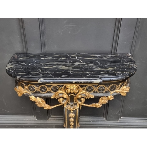 1201 - A neo-classical style ebonized, parcel gilt and marble top console table, 78.5cm wide.... 