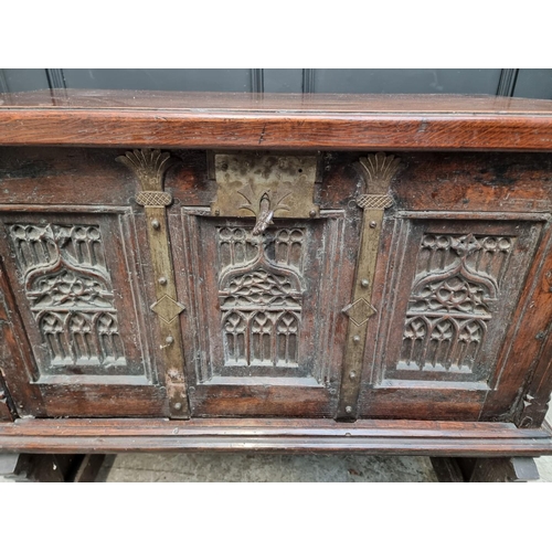 1241 - A 16th century and later oak side cabinet, with fall front and trestle supports, 91cm wide.... 