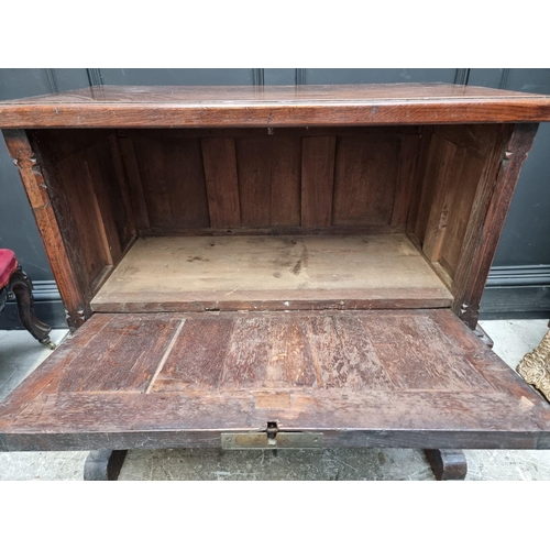 1241 - A 16th century and later oak side cabinet, with fall front and trestle supports, 91cm wide.... 