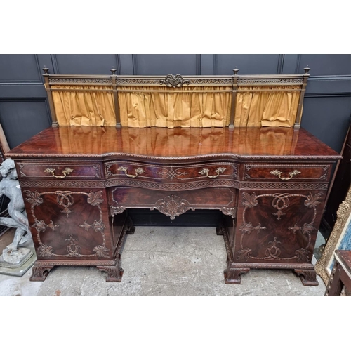 1266 - A large and impressive early 20th century carved mahogany sideboard, with original brass galler... 