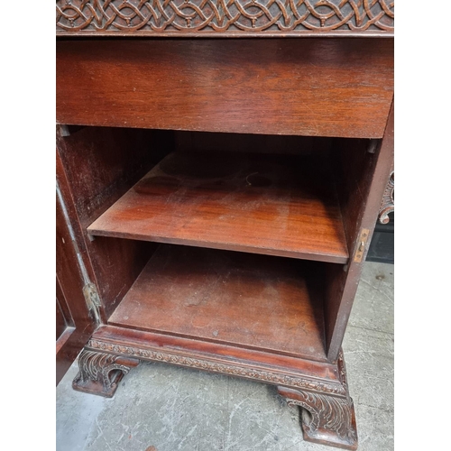 1266 - A large and impressive early 20th century carved mahogany sideboard, with original brass galler... 