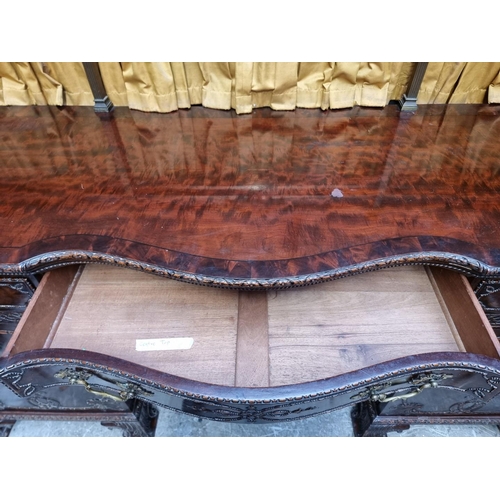 1266 - A large and impressive early 20th century carved mahogany sideboard, with original brass galler... 