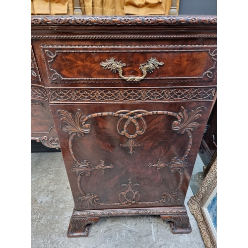 1266 - A large and impressive early 20th century carved mahogany sideboard, with original brass galler... 