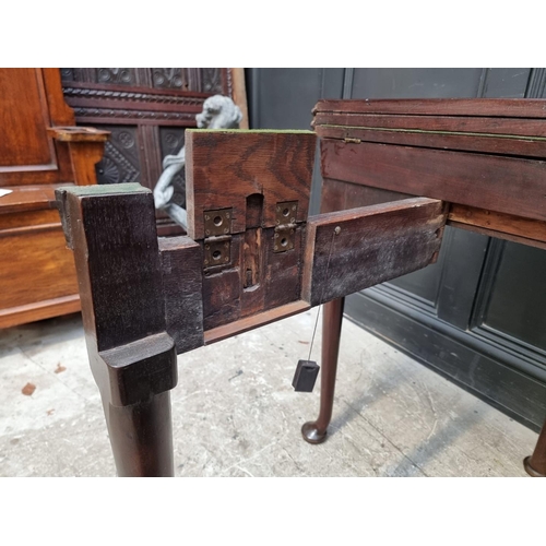 1273 - An 18th century 'red walnut' double fold-over card table, with single gateleg, 84cm wide.... 