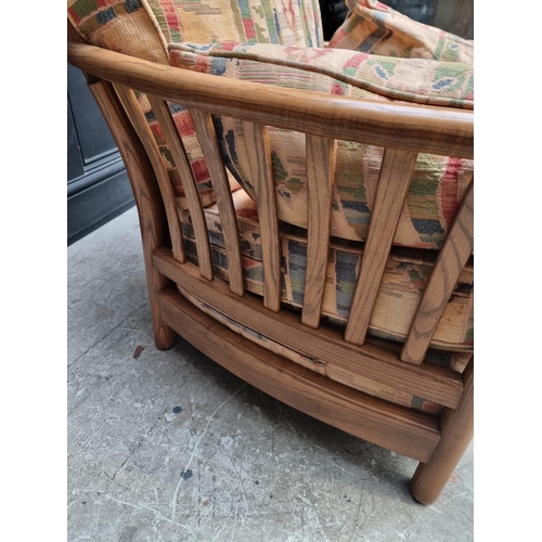 1277 - An Ercol two seater settee and matching armchair.