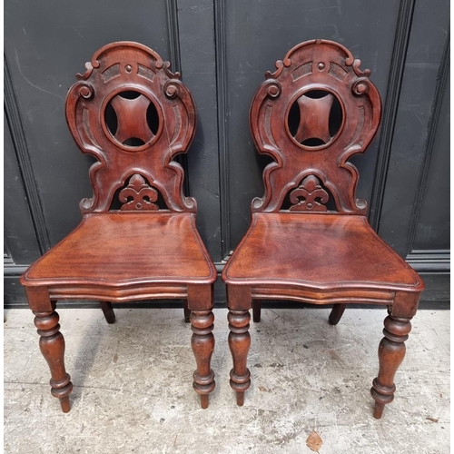 1282 - A pair of Victorian mahogany hall chairs.