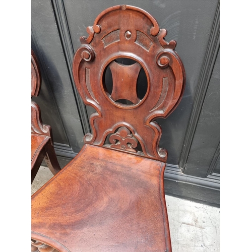 1282 - A pair of Victorian mahogany hall chairs.