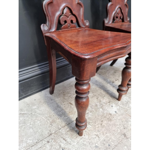 1282 - A pair of Victorian mahogany hall chairs.