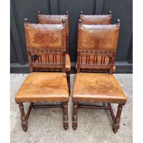 1283 - A set of four late 19th century carved walnut and embossed tanned leather dining chairs, with decora... 